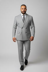 Man wearing grey double-breasted pinstripe suit with tailored fit for formal occasions.